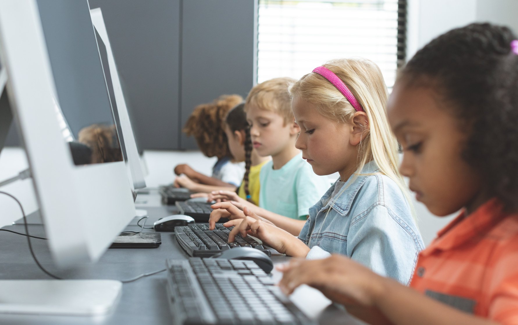 School kids using computer in school